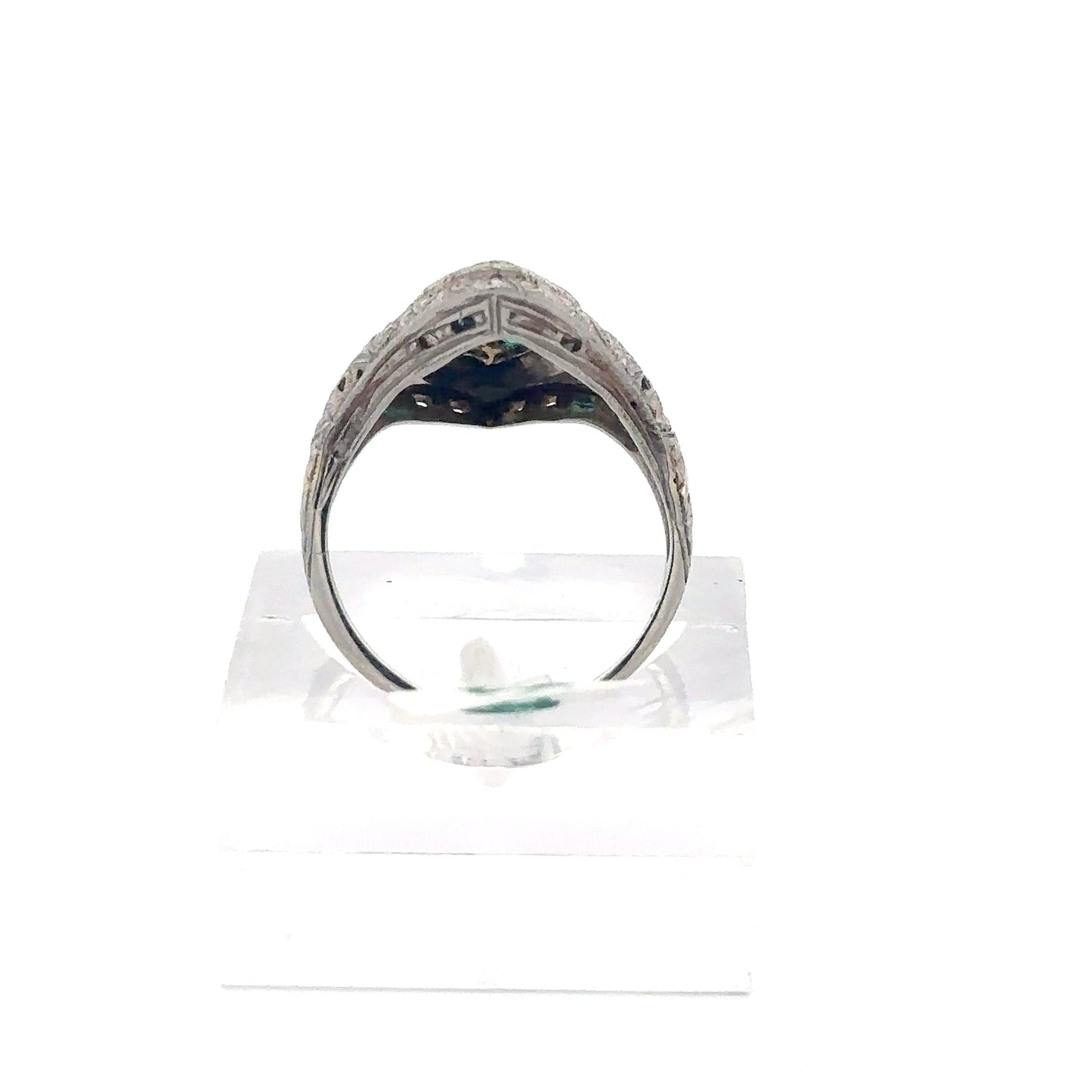 Antique silver shield ring with diamond and emerald gemstones, vintage jewelry piece with intricate design details.