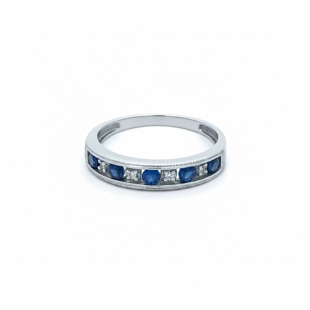 Vintage sapphire and diamond band in 14k white gold, featuring intricate design and sparkling gemstones.