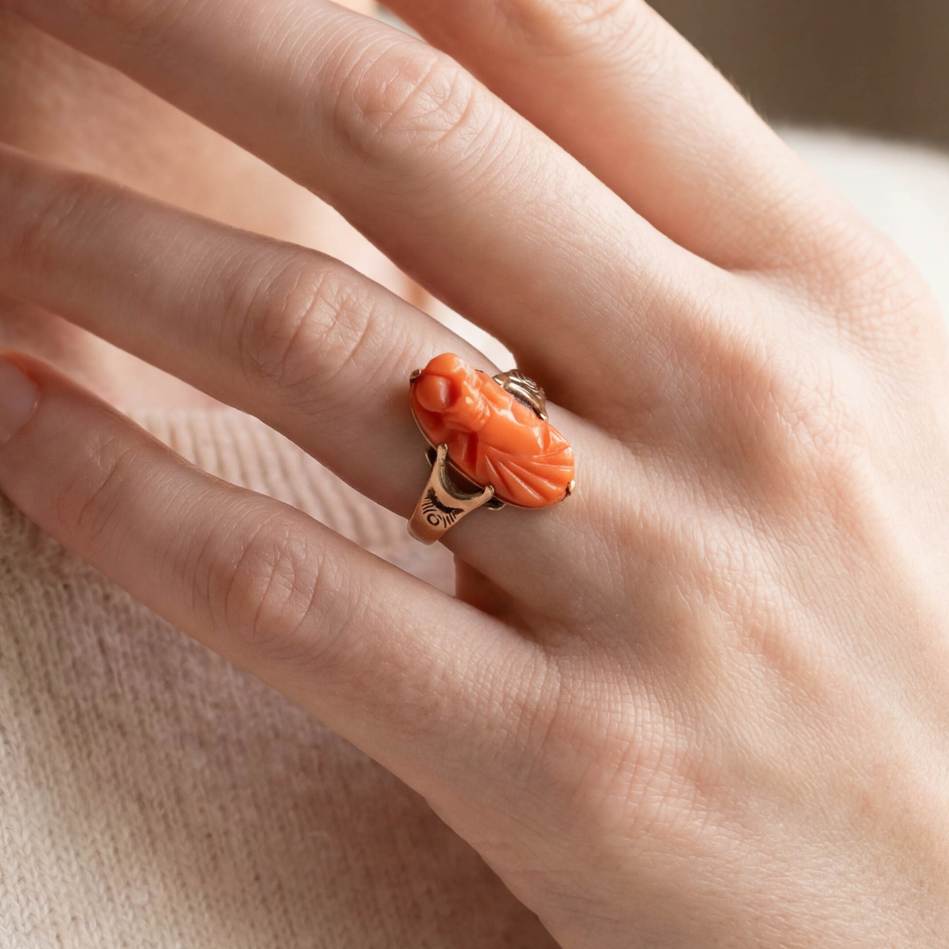 Antique hand-carved coral cameo ring in 10k yellow gold, featuring intricate vintage design and detailed craftsmanship.