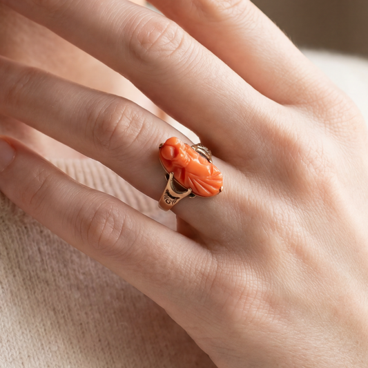 Antique hand-carved coral cameo ring in 10k yellow gold, featuring intricate vintage design and detailed craftsmanship.