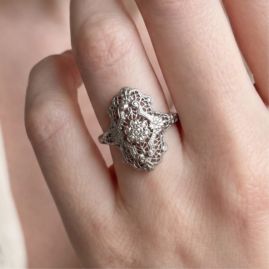Antique art deco diamond shield ring in 18k white gold from Silver Lady Vintage, featuring a detailed geometric design and sparkling diamonds.