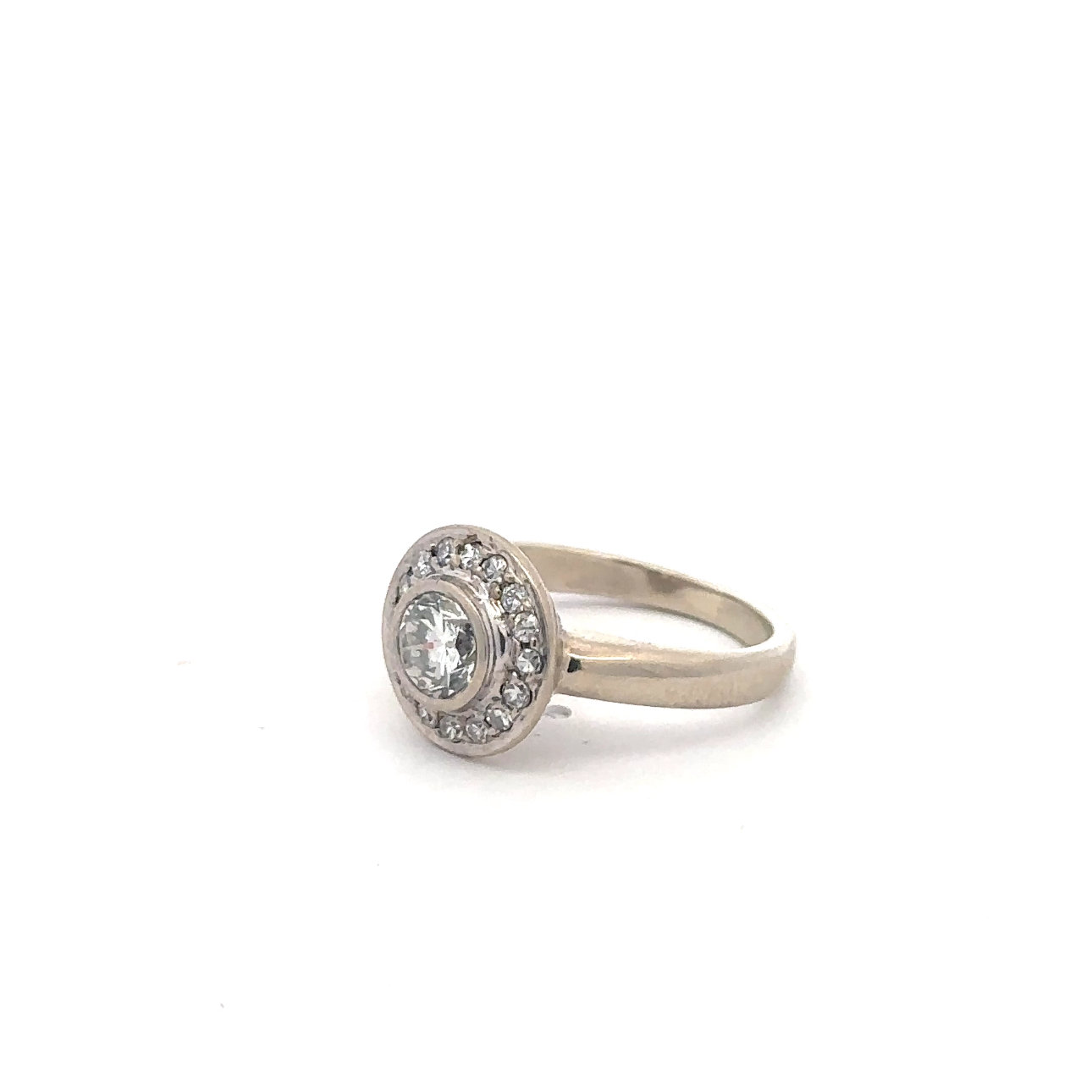 Vintage brilliant cut diamond halo ring in 14k white gold with intricate detailing, crafted by Silver Lady Vintage.
