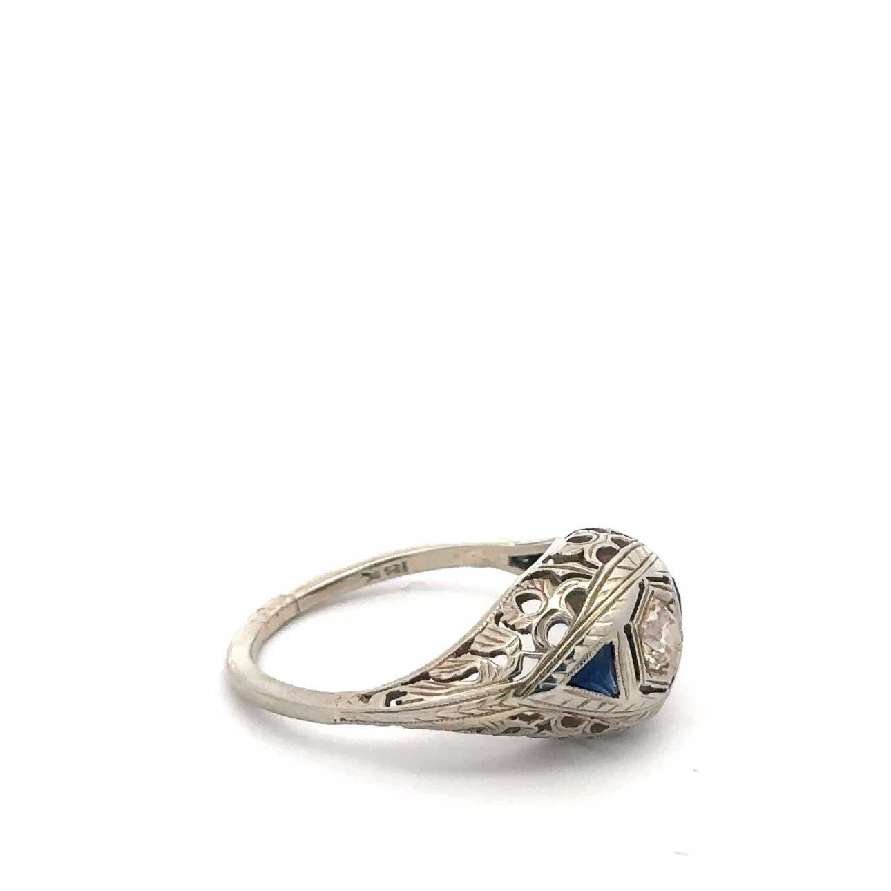 Art deco sapphire and diamond ring in 18k white gold with intricate vintage silver lady design and sparkling gemstone accents.