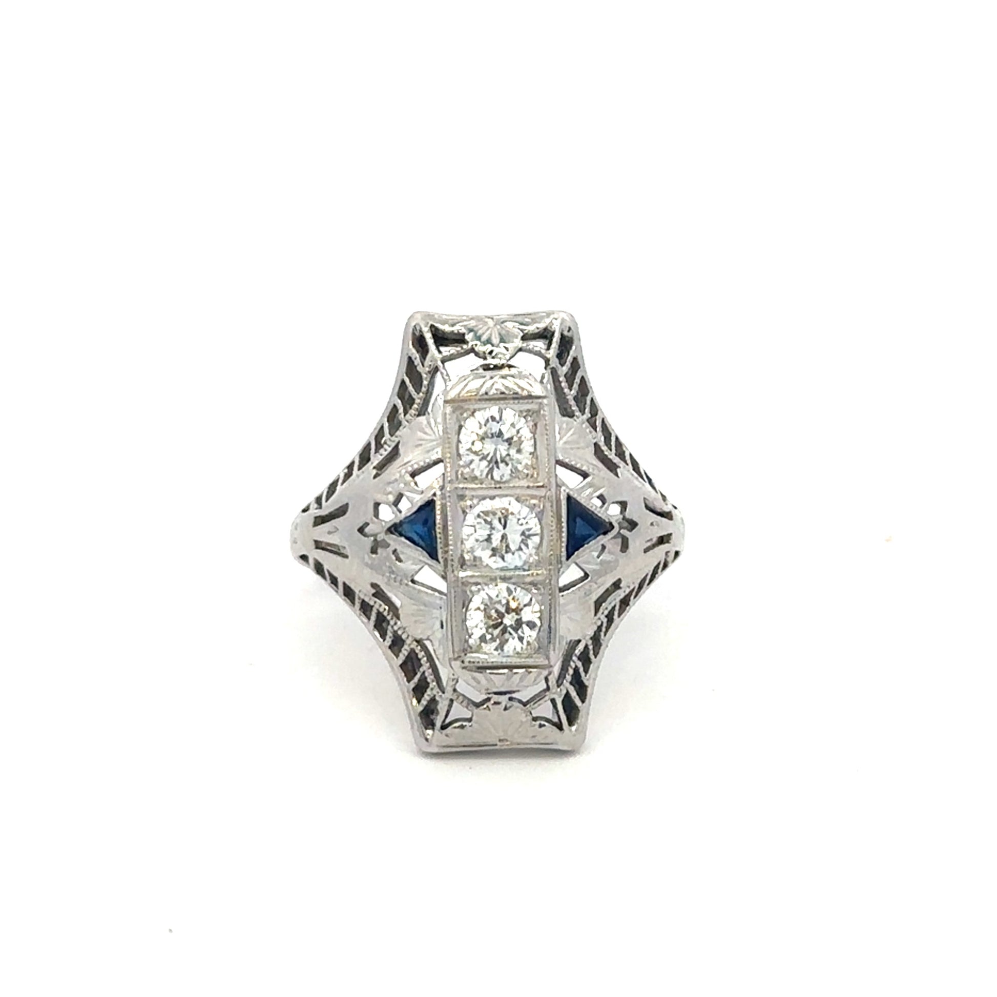 Art deco shield ring with sapphire and diamonds in 18k white gold, vintage Silver Lady design featuring intricate detailing.