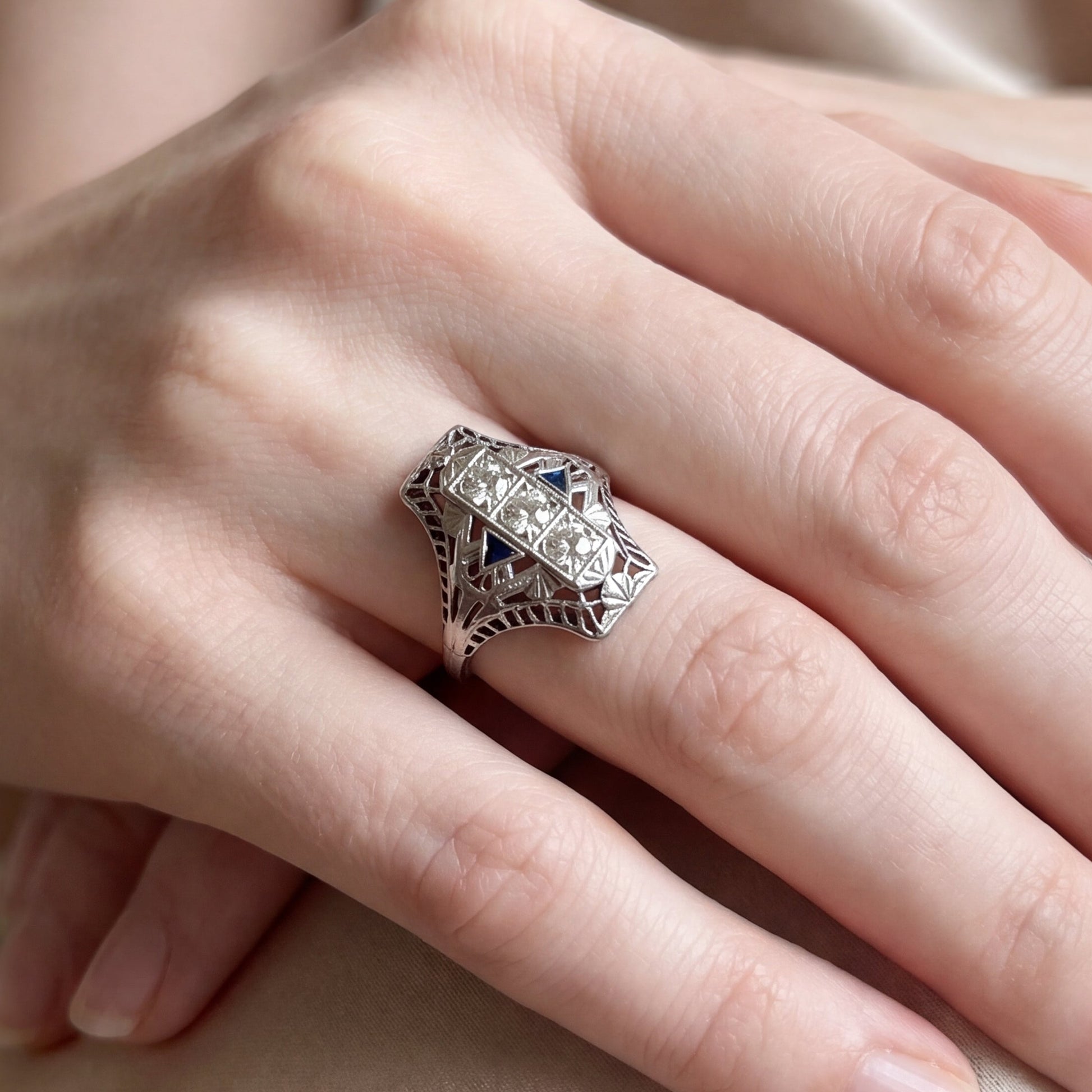 Art deco shield ring featuring sapphires and diamonds in 18k white gold by Silver Lady Vintage.