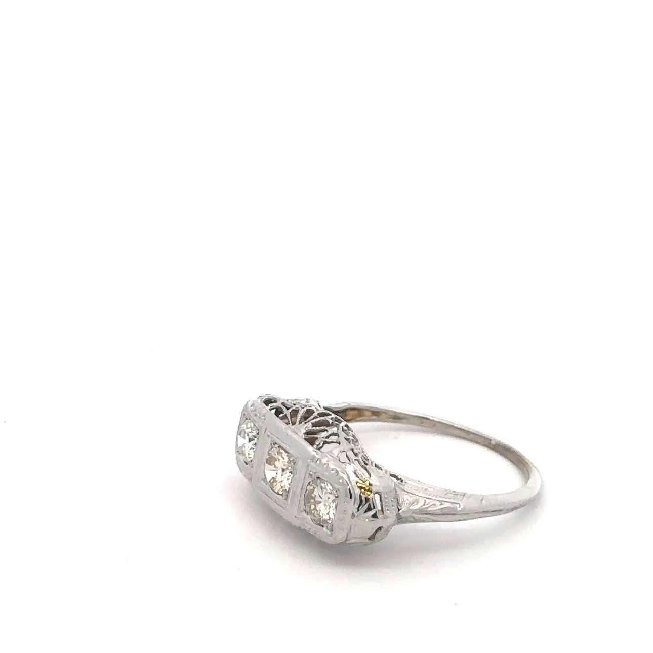 Art deco three-stone natural diamond ring in 18k white gold, showcasing elegant design and sparkling gemstones.
