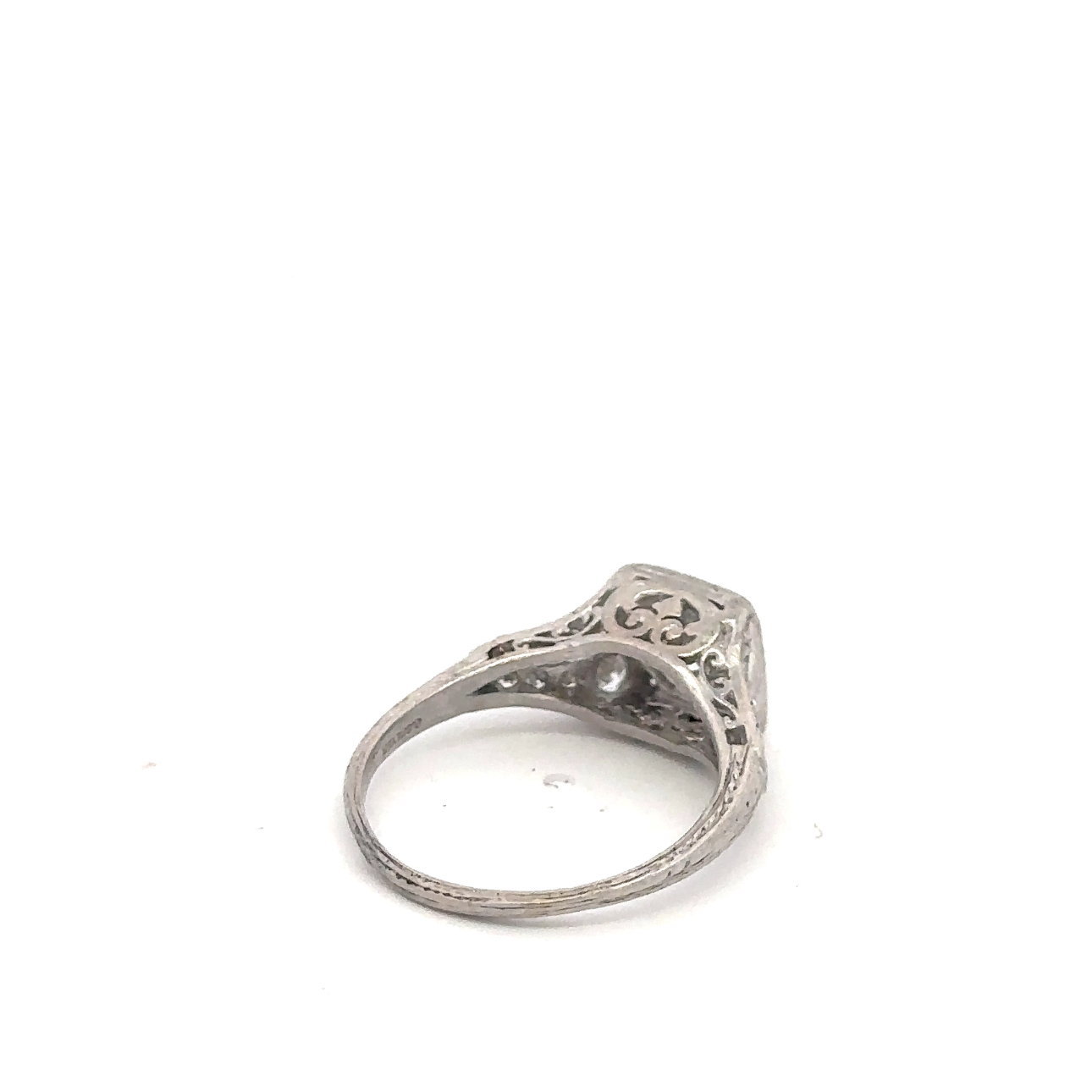 Art deco platinum ring featuring an old mine cut diamond from Silver Lady Vintage, showcasing intricate vintage jewelry craftsmanship.