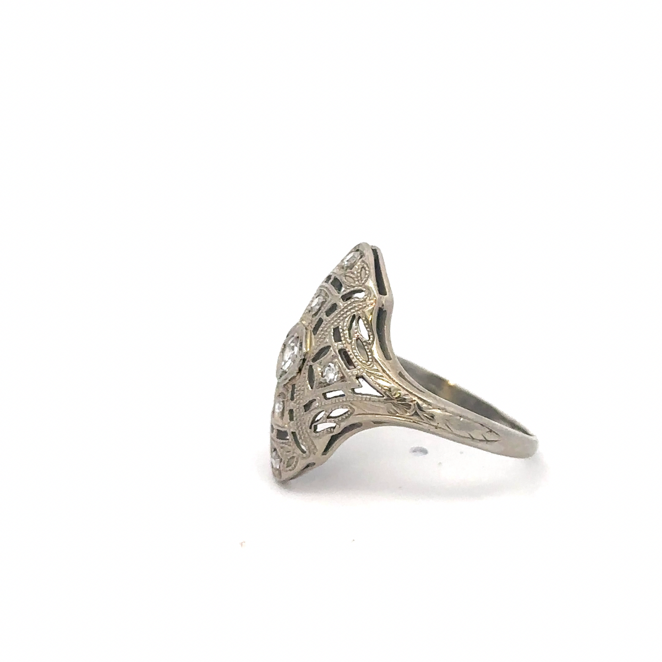 Art deco diamond shield ring crafted in 18k white gold by Silver Lady Vintage, showcasing intricate design and sparkling gemstone details.