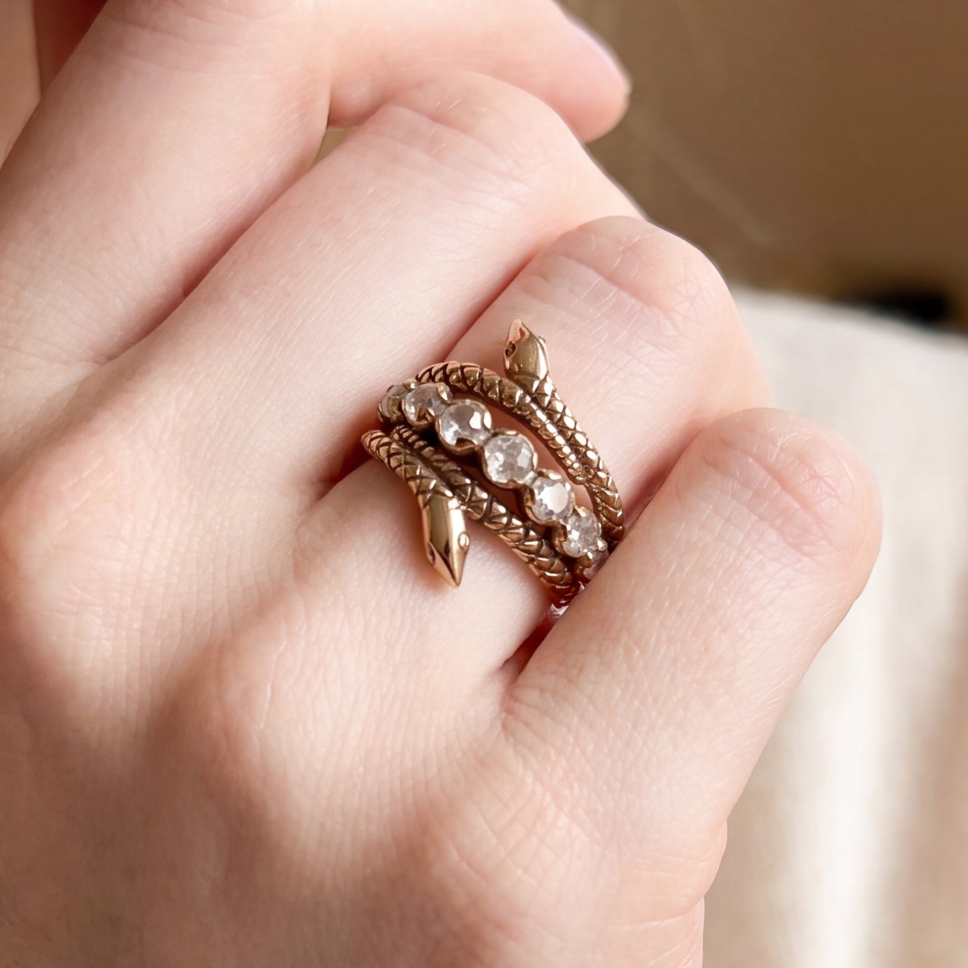 Stacking serpent rings in 9k gold featuring Silver Lady Vintage's original design, shown on a finger.