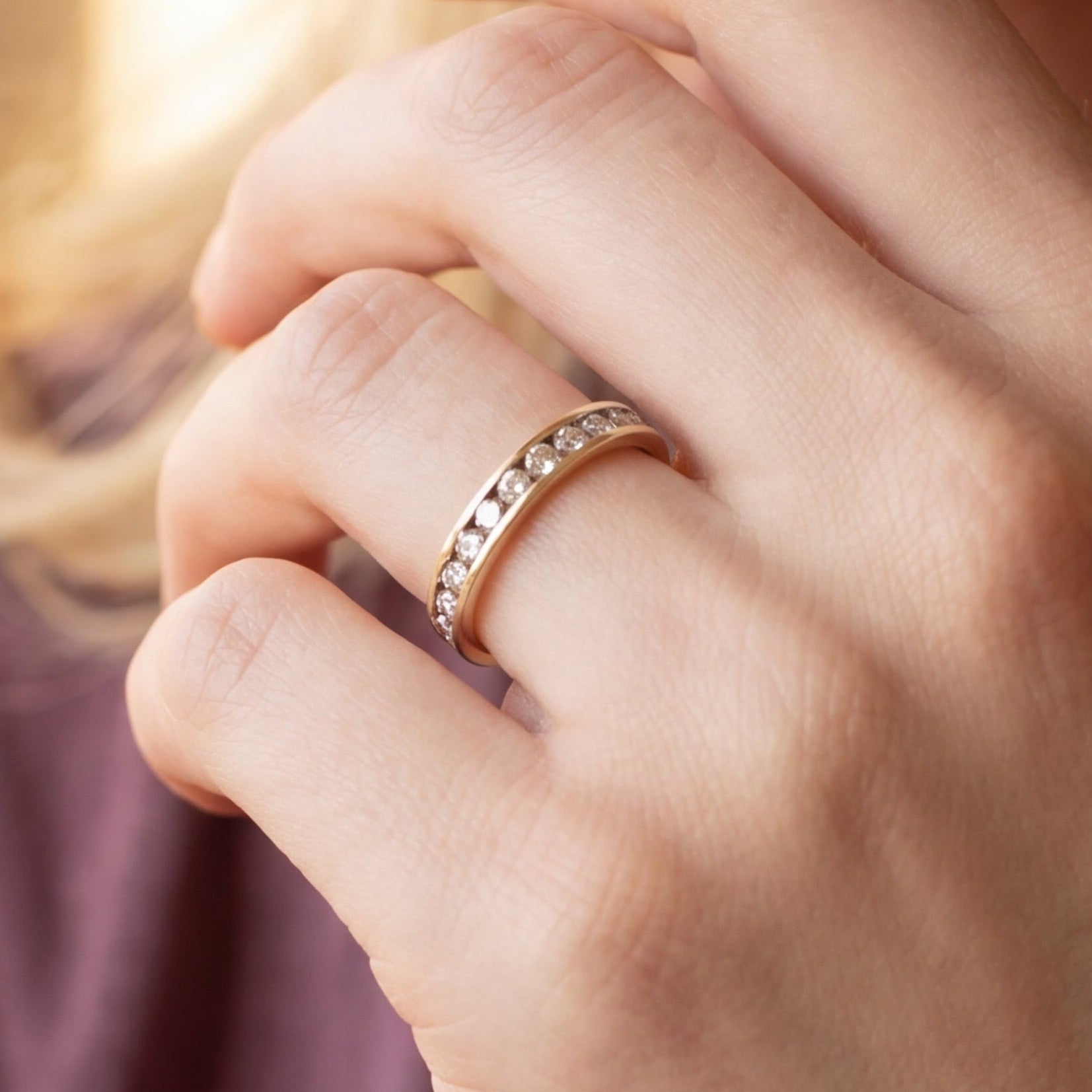Channel set diamond band in 10k yellow gold, showcasing a sleek vintage style with sparkling diamonds and polished gold finish.