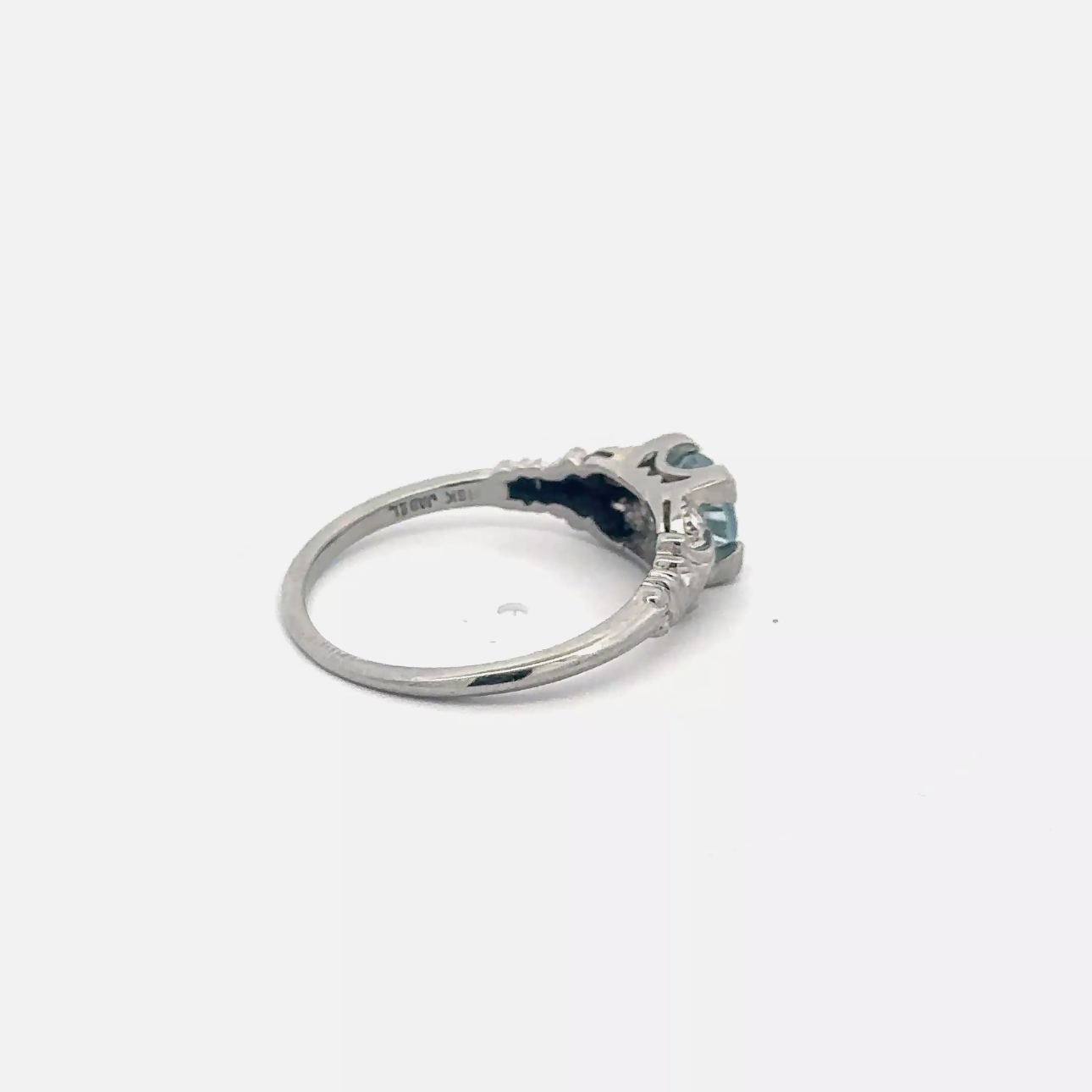 Vintage aquamarine solitaire ring in 18k white gold with a silver lady vintage branding, showcasing the gemstone and elegant design.