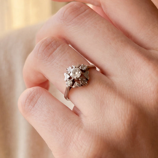 Art Deco floral motif diamond ring in 18k white gold, Silver Lady Vintage jewelry with intricate design and sparkling diamonds.