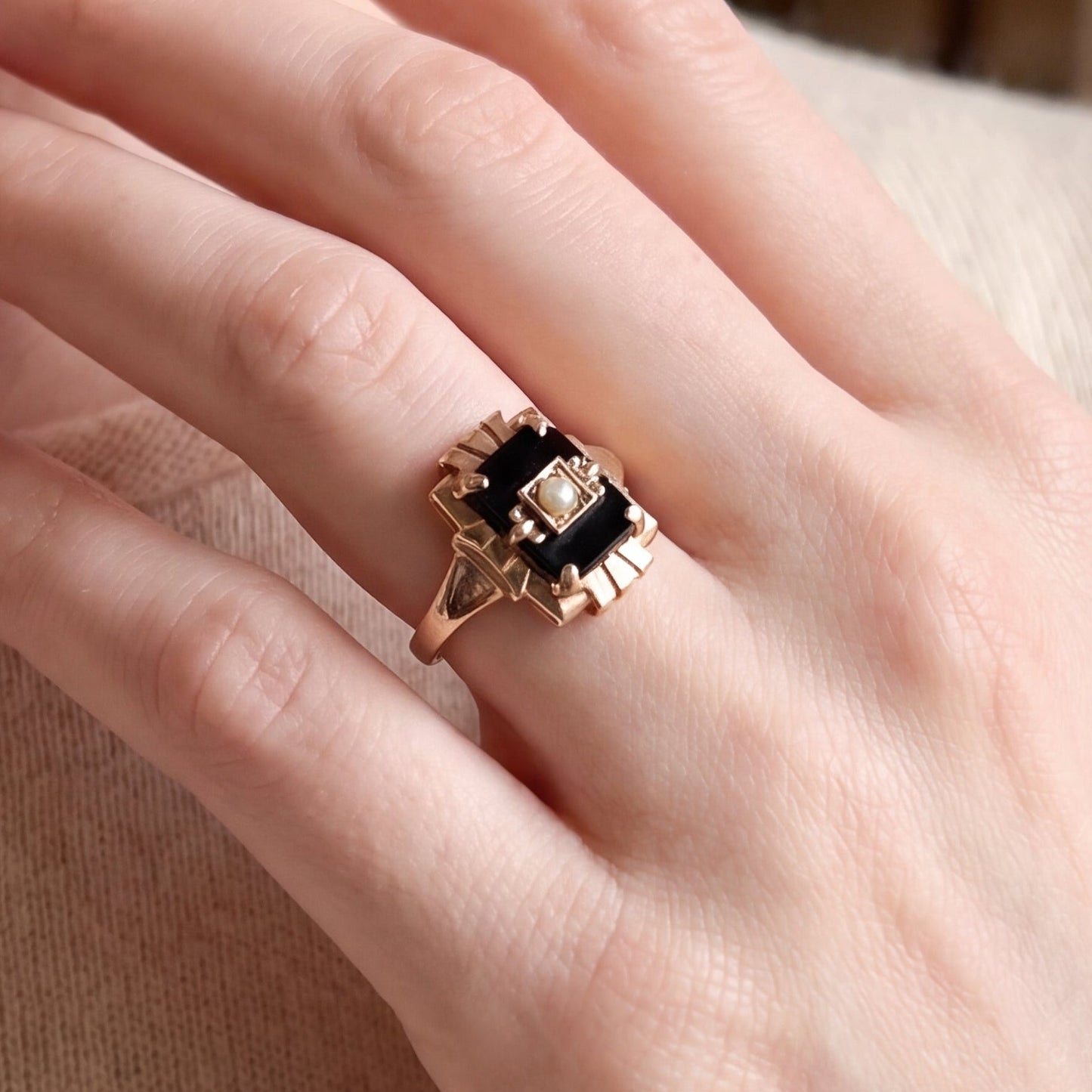 Vintage 1940s onyx and pearl ring in 10k yellow gold, detailed close-up showing intricate design and craftsmanship.
