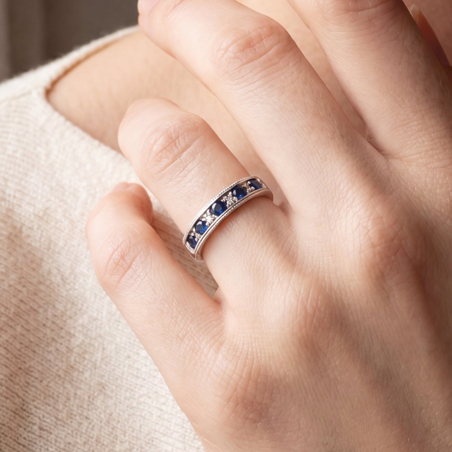 Vintage sapphire and diamond band in 14k white gold, featuring intricate detailing and a classic design.