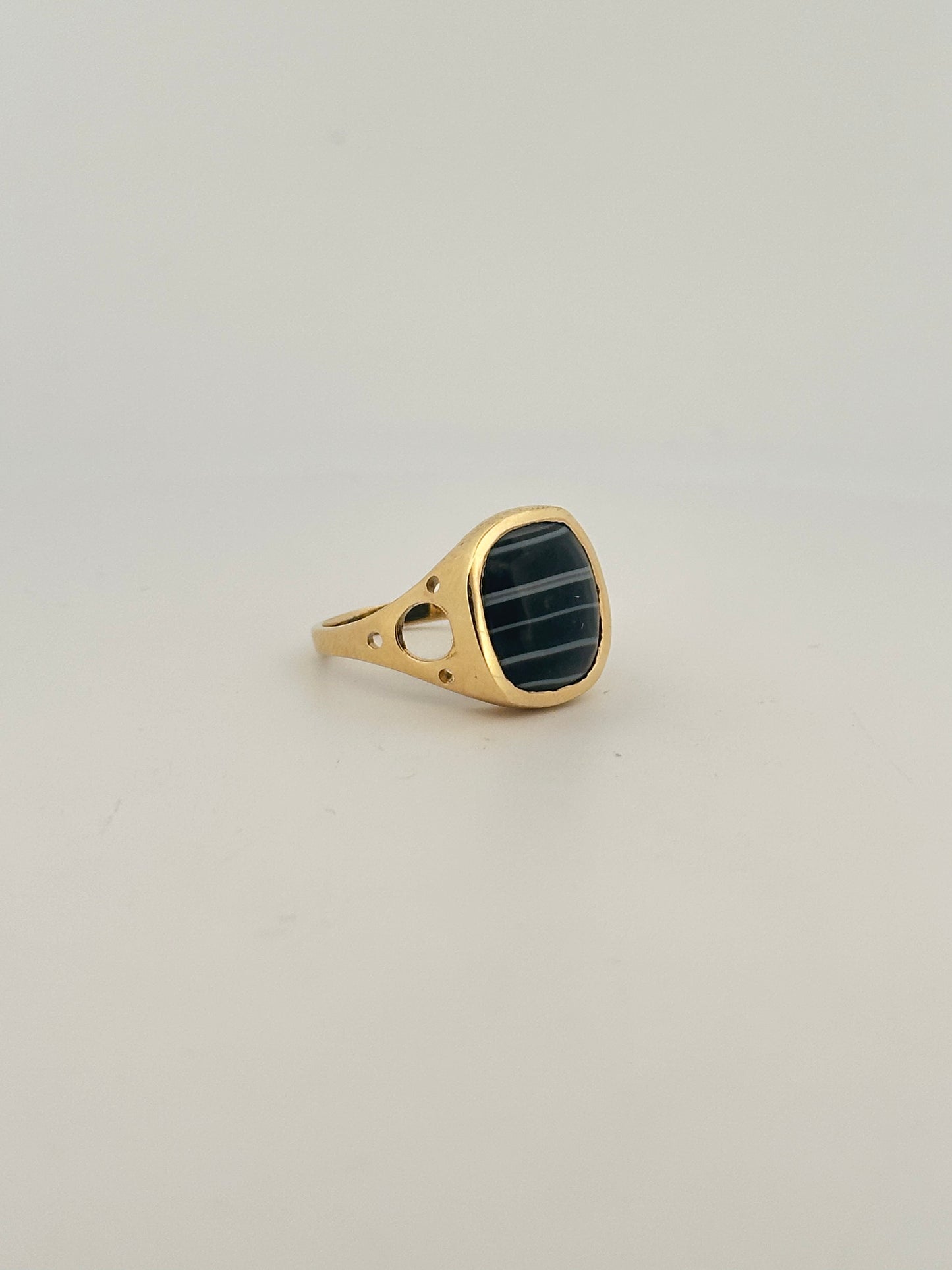 Black banded agate bezel set ring in 10k yellow gold