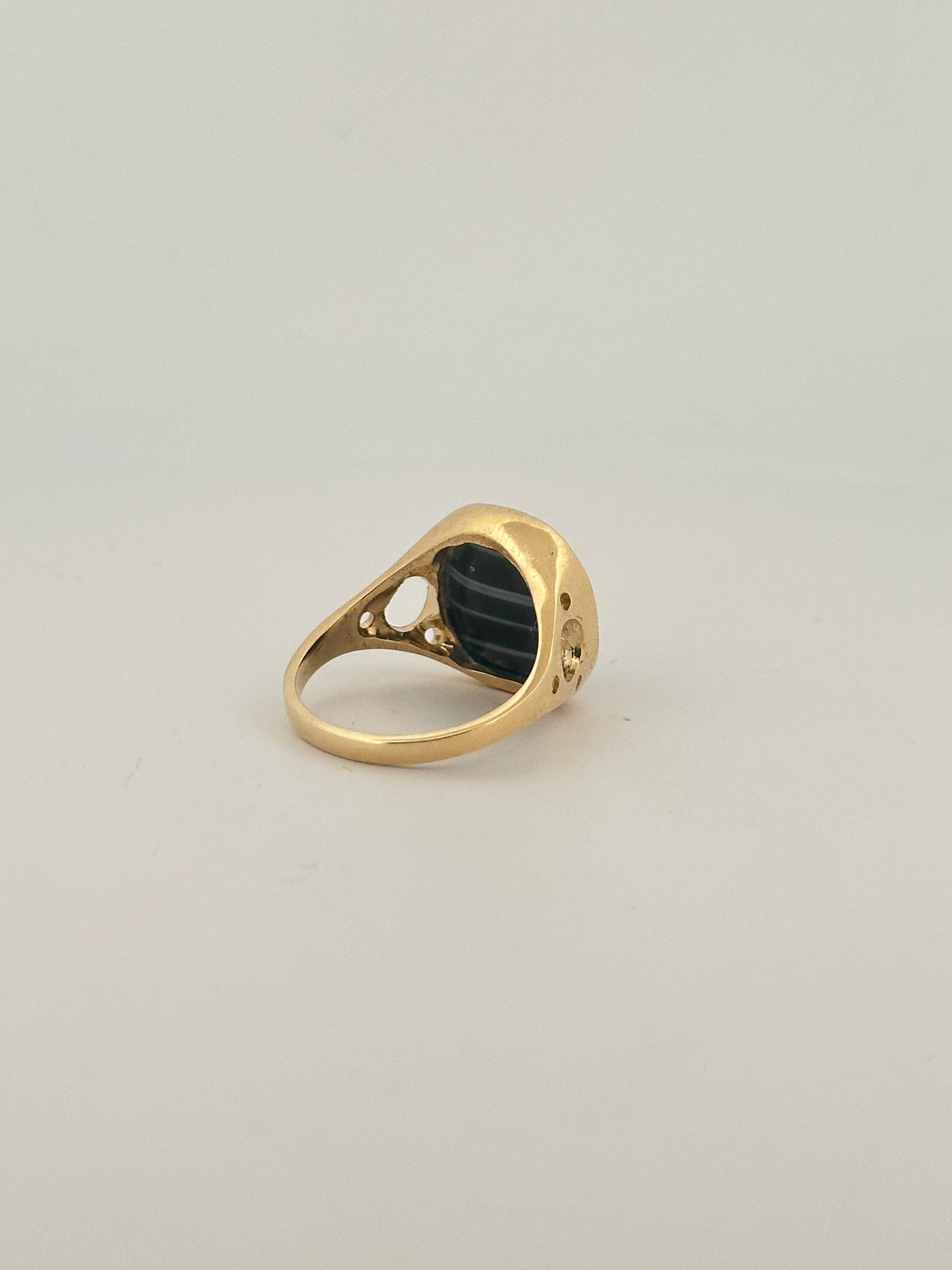 Black banded agate bezel set ring in 10k yellow gold