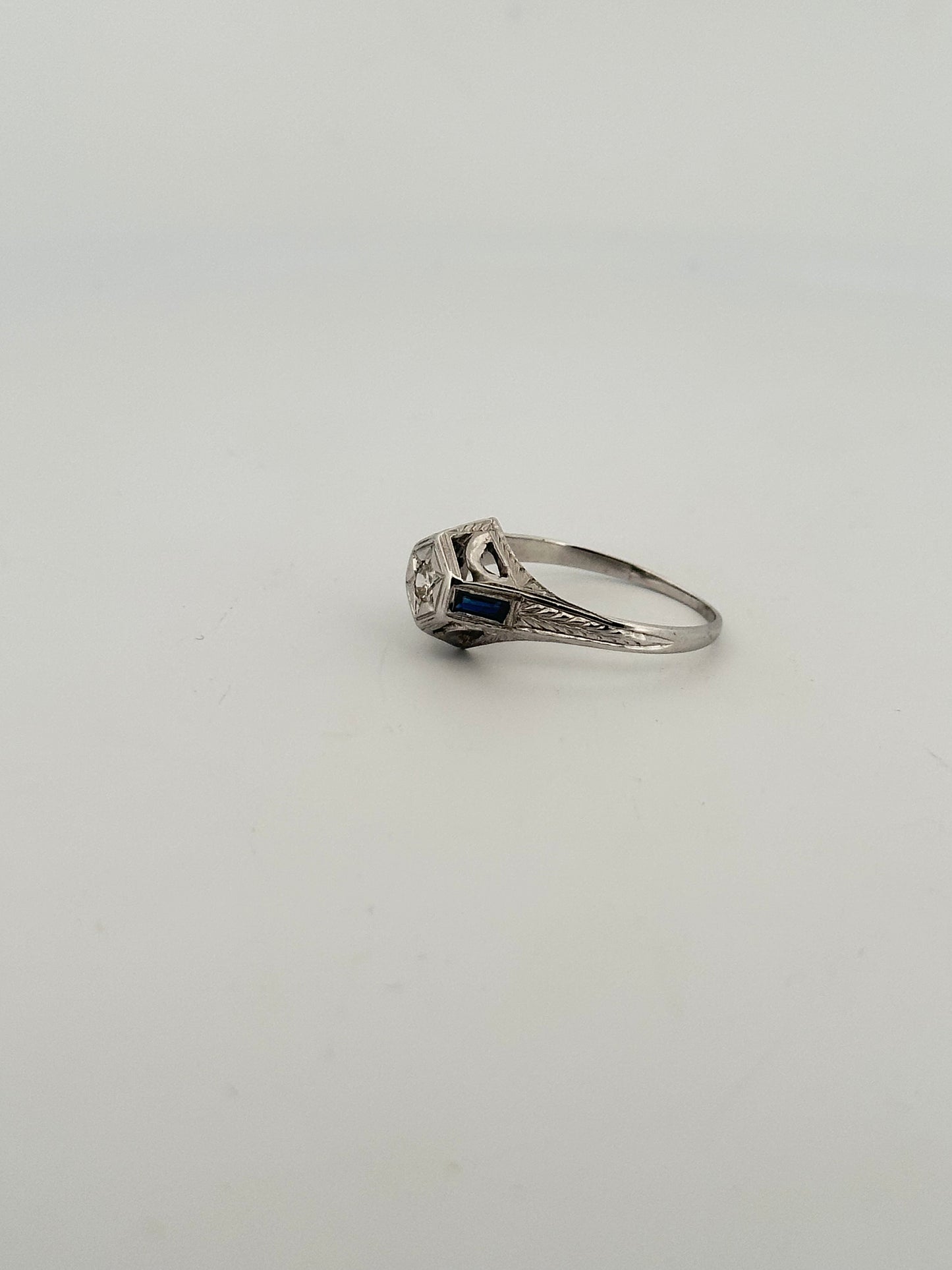 Antique art deco diamond solitaire with sapphire accents in 18k white gold