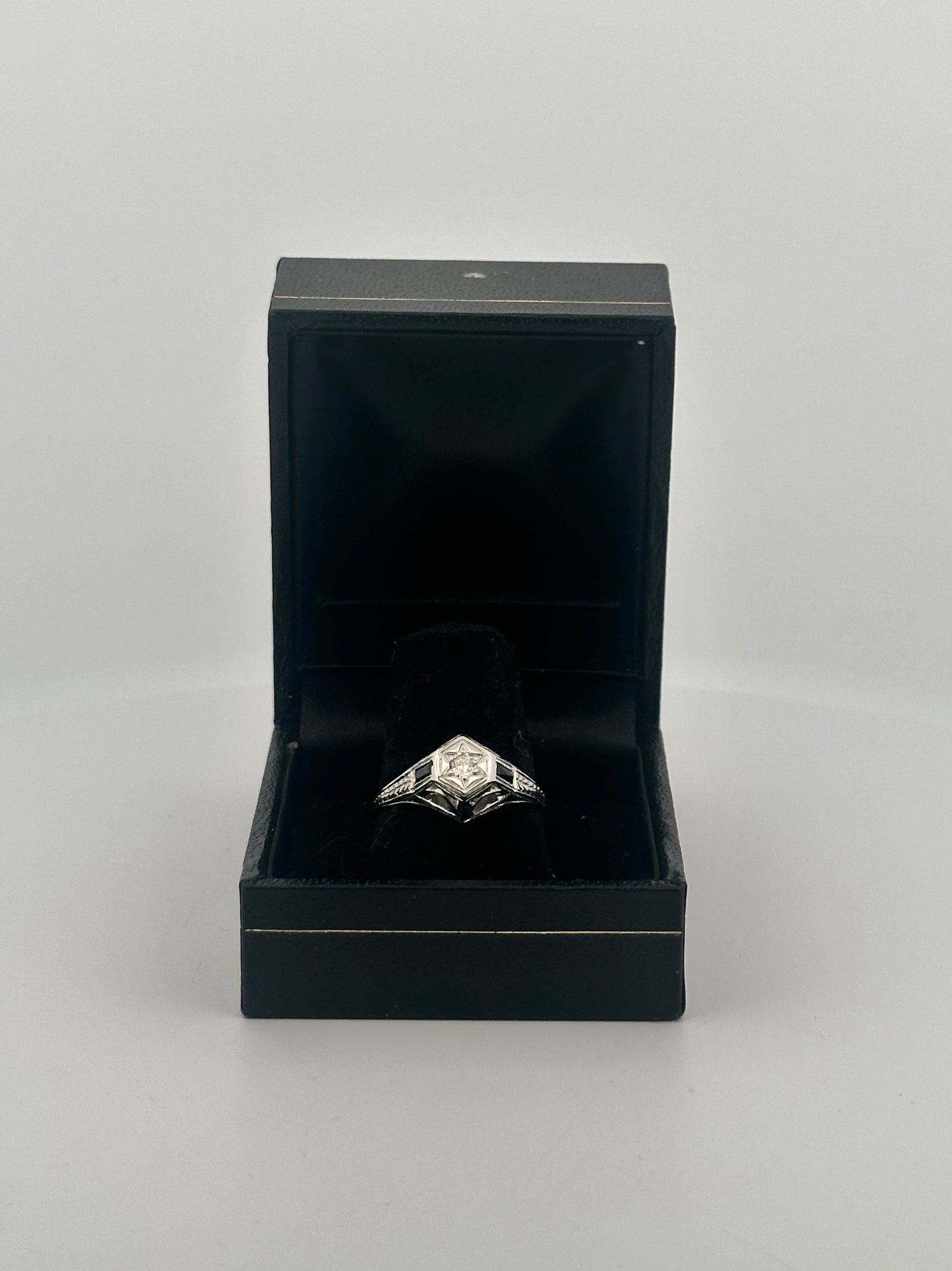 Antique art deco diamond solitaire with sapphire accents in 18k white gold